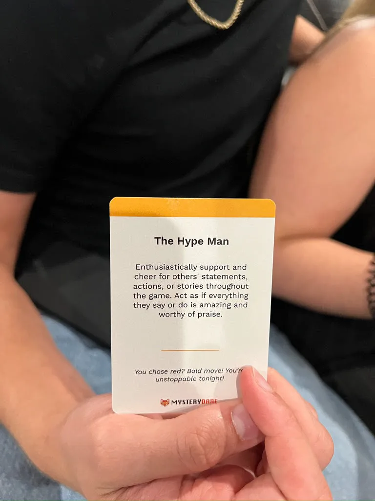 A person holding a dare card reading 'The Hype Man'